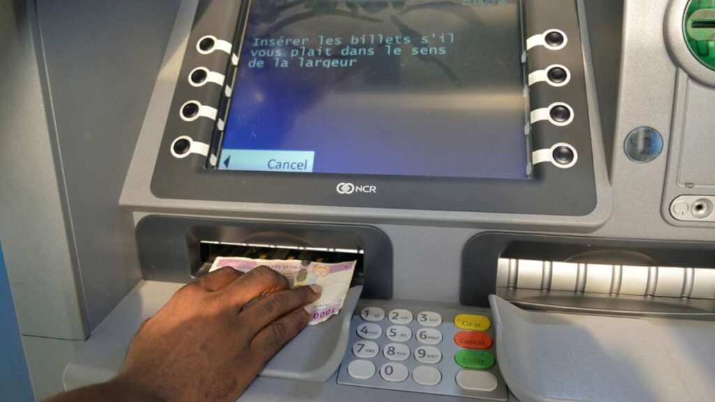 Person Withdrawing cash from an ATM in Cameroon